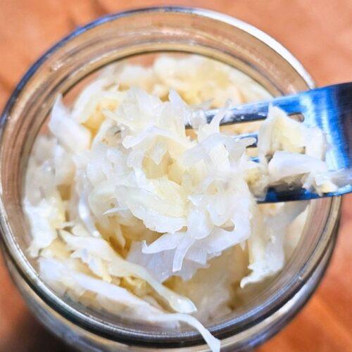 Fork with sauerkraut in jar
