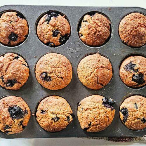 Freshly baked blueberry muffins in tray